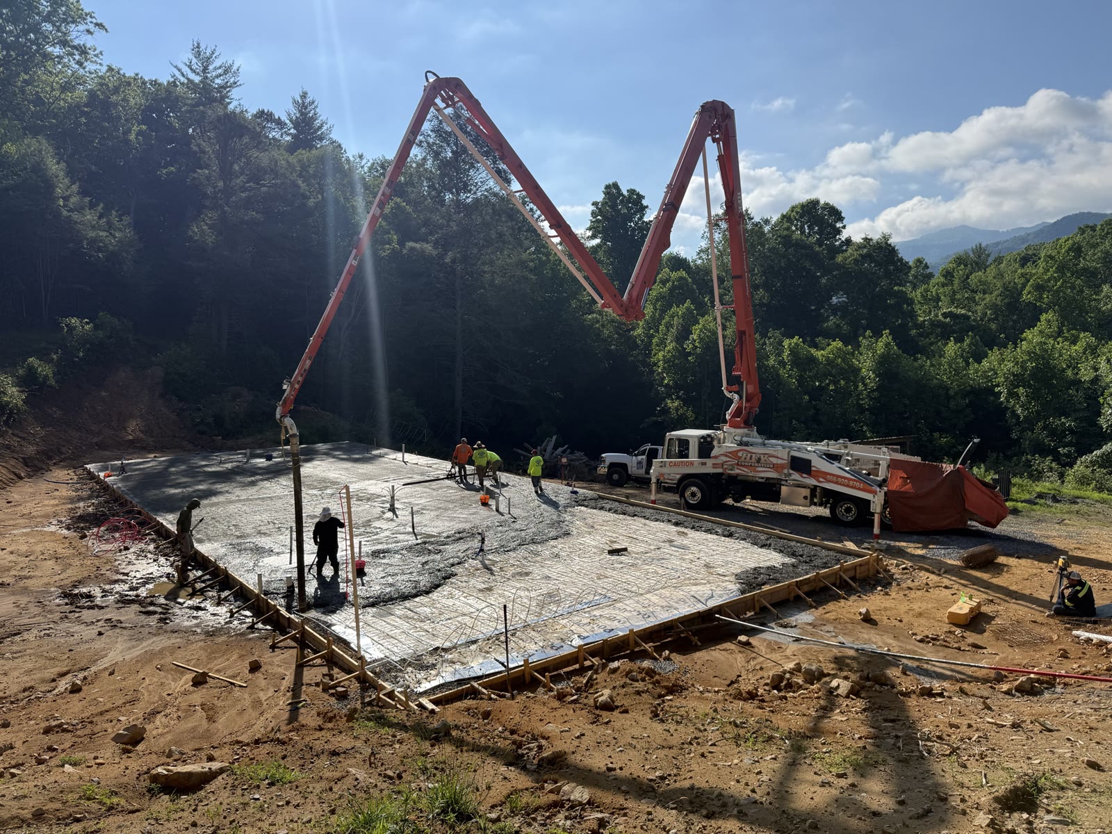 Concrete slab being poured on the prepared pad.