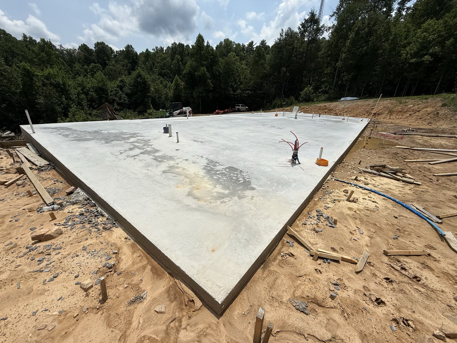 Slab with plumbing stub-ups protruding through the surface.