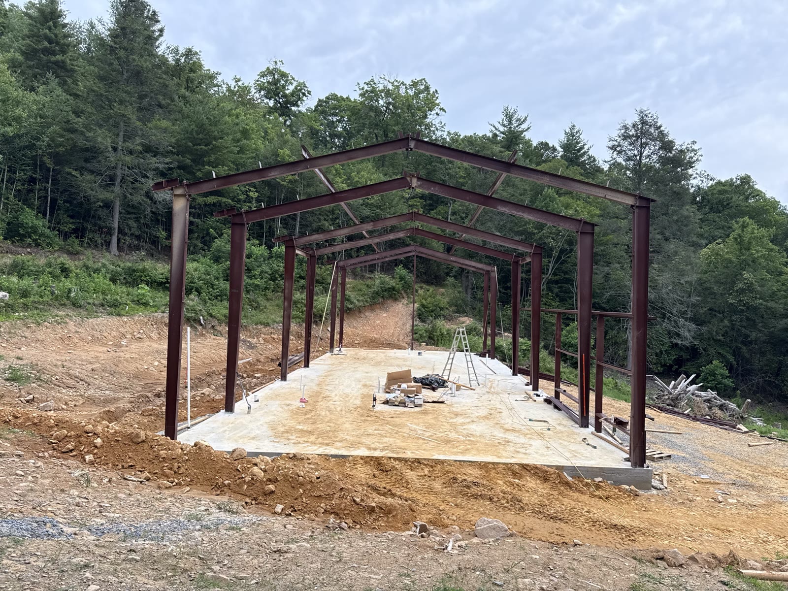 Rigid-frame skeleton fully erected with rafters and purlins in place.